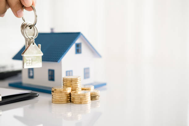 istock Real estate agent with house model and keys 1696931208