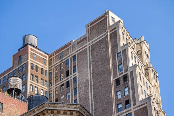 Broadway, Manhattan, New York, USA - August 11th 2023:  Traditional wooden water tanks on the roof of a classic New York building