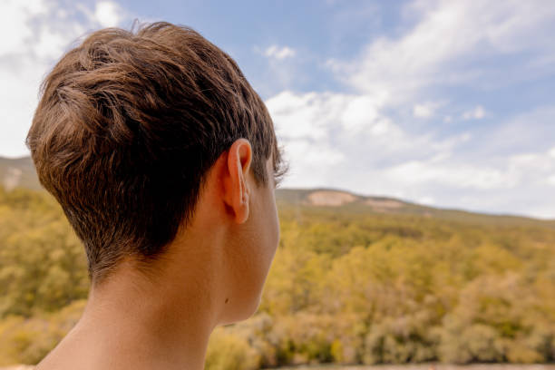 young girl looking at the horizon in a natural mountain landscape