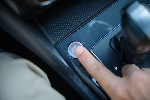 istock Start engine button. Male finger pushing start engine button of the car 1696945052