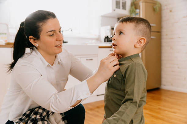 istock Mother dressing up her little boy at home 1696974401