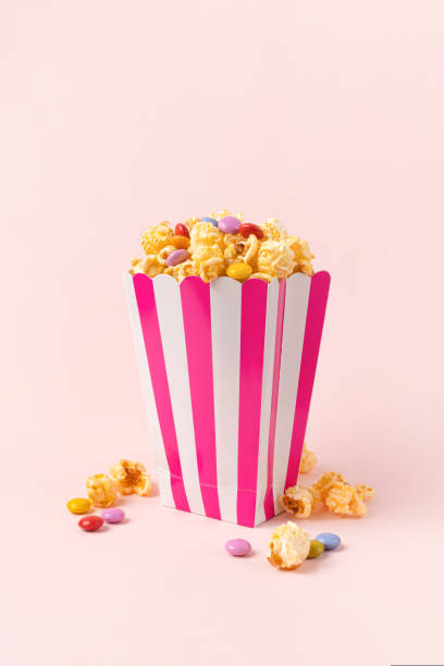 istock sweet popcorn with dragee on pink background 1696979822