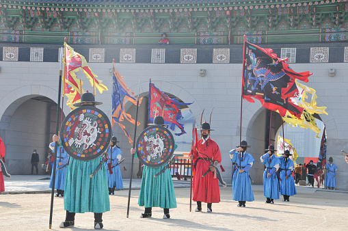 Seoul, South Korea - October 27, 2022: Korean ancient old soldier warriors guard changing event among many tourists in Gyeongbokgung Palace front ground.Seoul, South Korea - October 27, 2022: Korean ancient old soldier warriors guard changing event among many tourists in Gyeongbokgung Palace front ground.