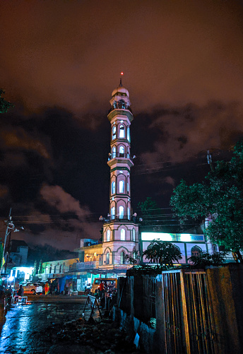 Mosque minaret illuminated in the night sky. Dhaka , Bangladesh. may 6 2023