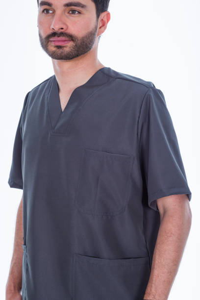 istock Doctor in a white photo studio modeling his anti-fluid uniforms. 1697047216