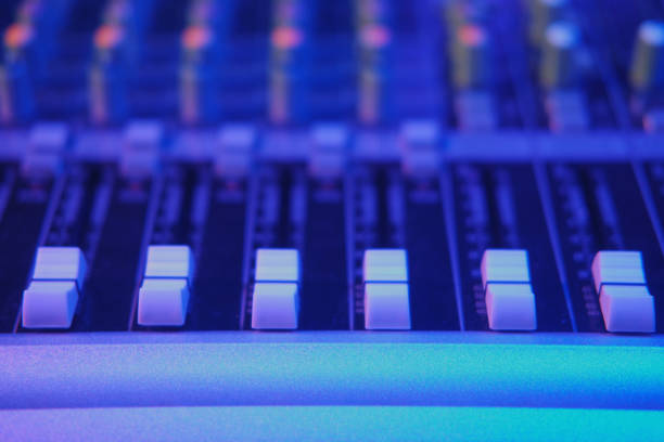 istock Close up of sound mixer control panel with blue light. Selective focus. 1697050612