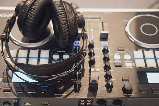 Closeup of a dj mixer with headphones. Selective focus.