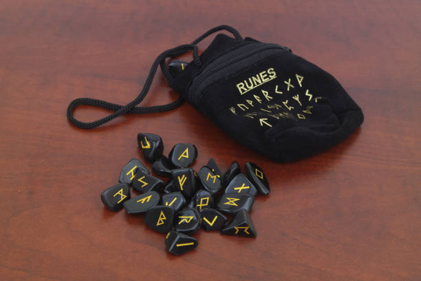 istock Stone runes on wooden table. 1697051756