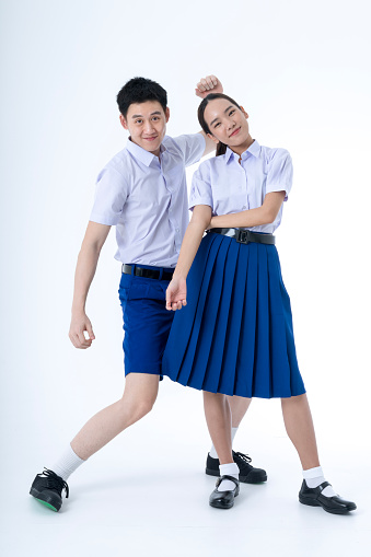 Back to School. Thai students. School children wearing school uniforms are dancing on white background.