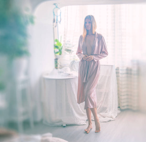 istock Young  woman in white room 1697090702