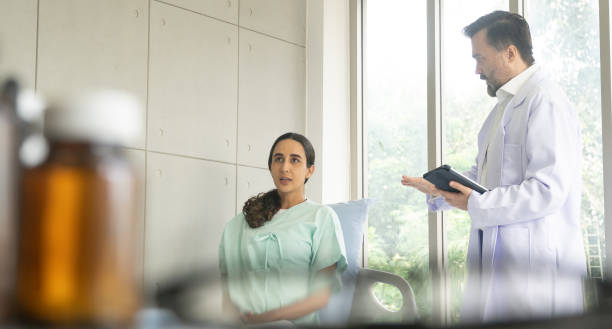 istock Caucasian male physician diagnosis for root cause finding working on tablet with Hispanic female patient. The medical healthcare exam and check-up with the doctor concept. 1697105754