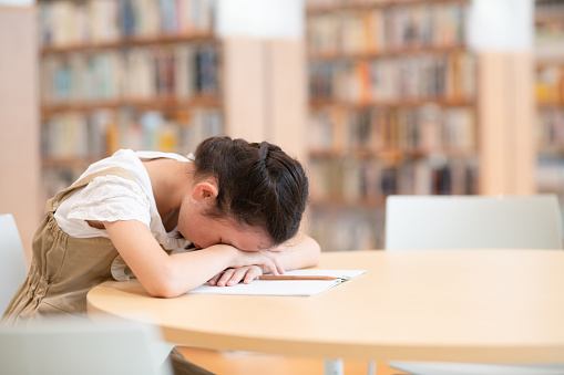 girl falling asleep while studying