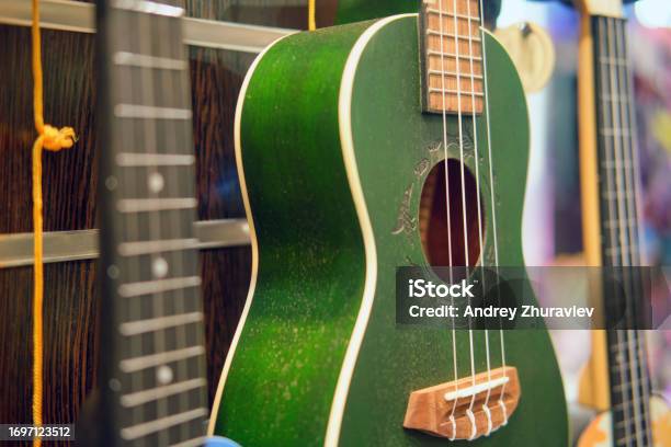 Green Ukulele In A Music Shop Small Green Guitar Stock Photo - Download Image Now - Acoustic Guitar, Acoustic Music, Art