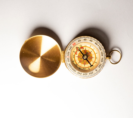 Vitage brass compass with sun-dial isolated on white background.