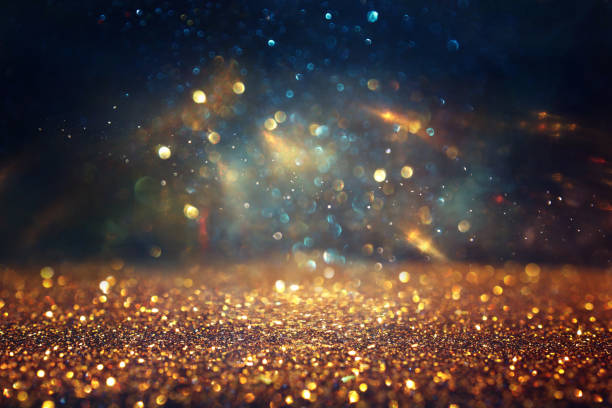 istock background of abstract glitter lights. gold, blue and black. de focused 1697140444
