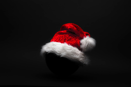 Red Christmas hat against dark background
