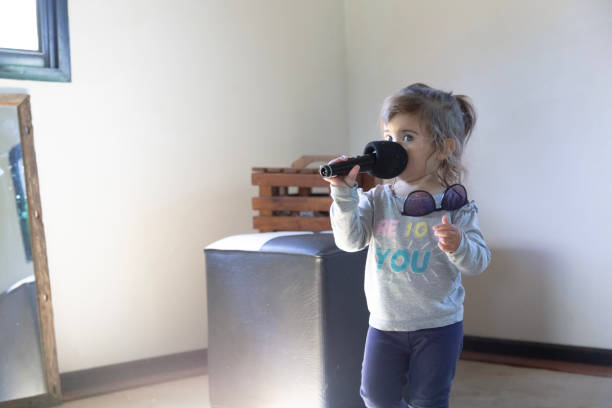 istock little girl playing with microphone 1697146958