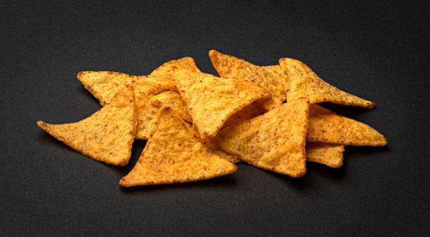 istock Corn chips, hot Mexican nachos isolated on black background 1697147889