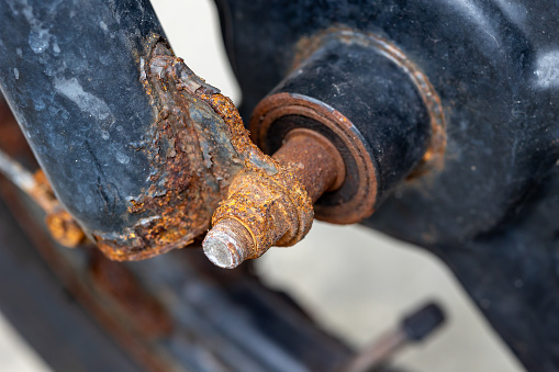 Rusty bolt and nut, shaft front a bike