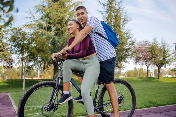 istock Young couple coming for exercise on a bike 1697150781