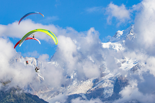 Mont Blanc, France - September 20, 2023: paraglider flying next to the tallest mountain in Alps