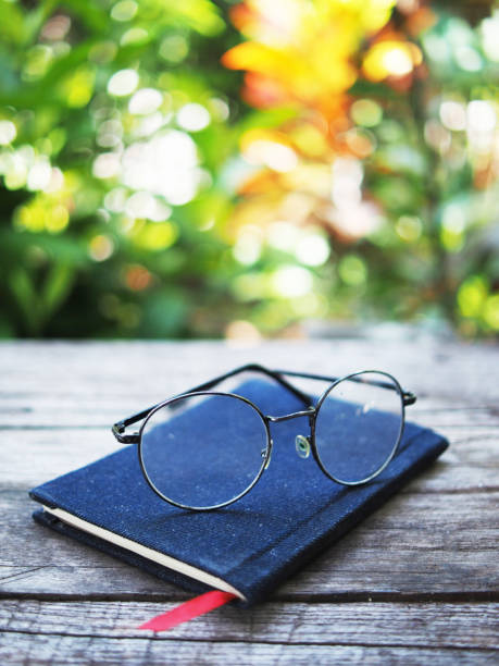 istock note book and glasses on wood table old style writter and reader 1697180236