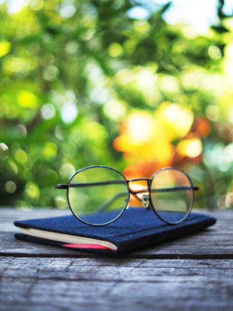istock note book and glasses on wood table old style writter and reader 1697181800
