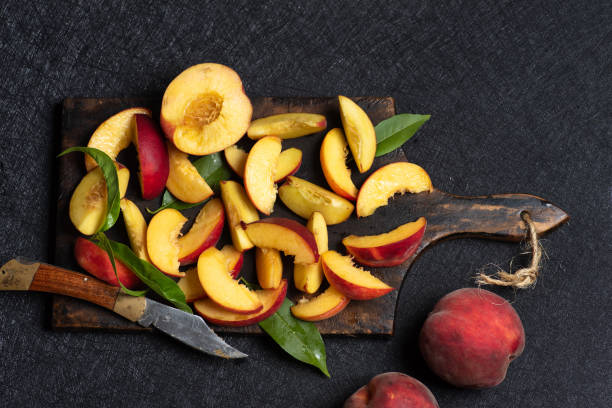 istock Slices of peaches on cutting board 1697201207