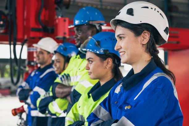 istock Group of engineering team happy worker diversity technician. woman engineers standing arm crossing in assembly plant. Industry staff working people teamwork concept. 1697201799