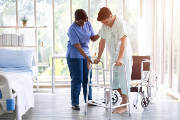 istock Patient muscle recovery walking training practice using walker with physiotherapist care help support 1697201851