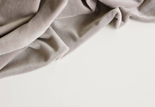 istock Velvet fabric texture drapery frame template beige color top view on beige  background. Copy space. 1697245967