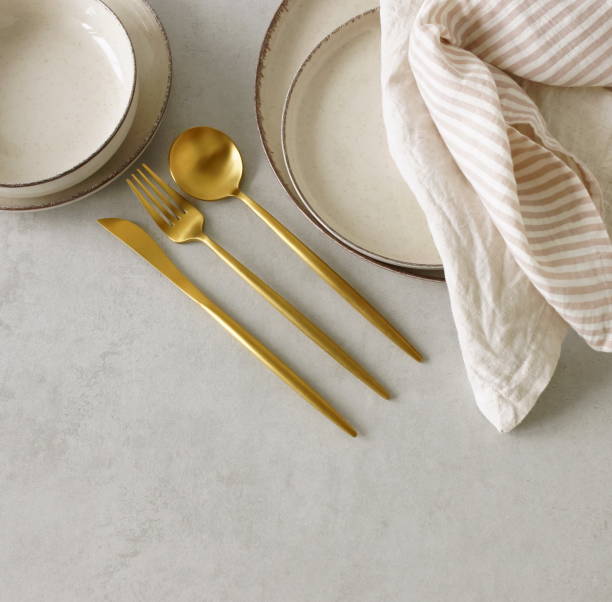 istock Modern minimal table place setting neutral beige color on beige concrete background top view with copy space. Modern kitchen.Scandinavian style tableware.Business food brand template. 1697246488