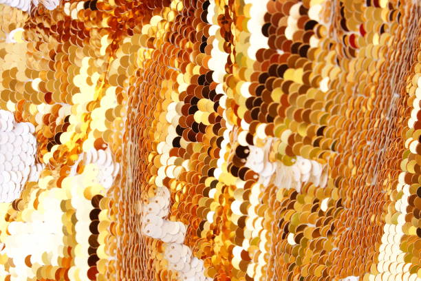 Gold Sequins fabric texture background. Abstract Xmas, festive sparkling backgrop. Selective focus