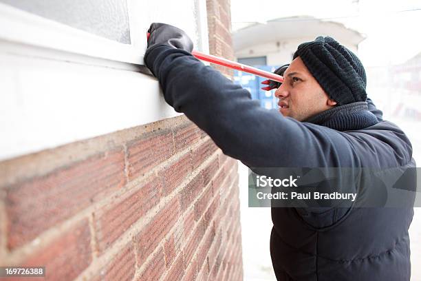 Burglar Prying Window Open With Crowbar Stock Photo - Download Image Now - 25-29 Years, Adult, Adults Only