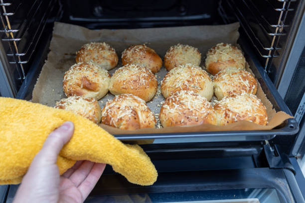 istock Freshly baked cheese bread buns in the oven 1697286043