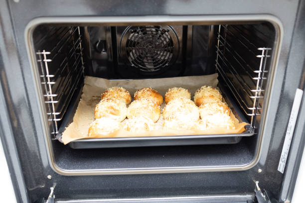 Freshly baked rolls in the open oven