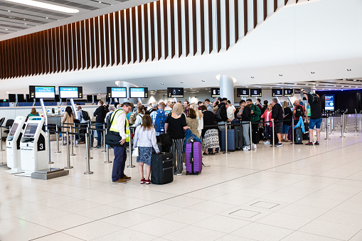Terminal 2, Manchester Airport, UK - September 14, 2023.  Air passengers and travellers queuing to check in and baggage drop at the new departure lounge at Terminal 2 of Manchester Airport