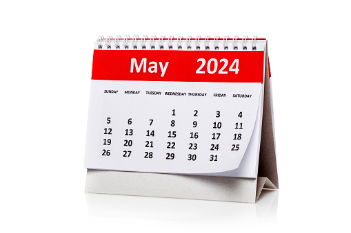 Desk calendar for April 2024 and a clock on the table