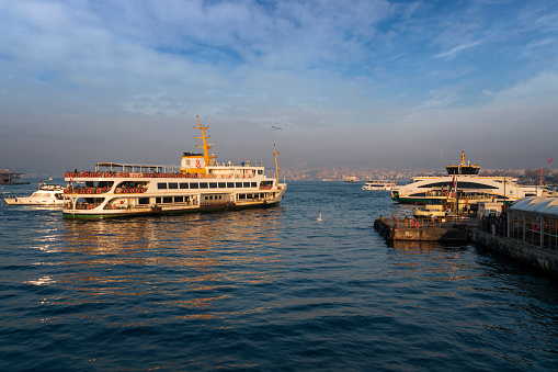 Istanbul, Turkey, 02.25.2023: View from the embankment of the Karakey ferry pier in the Beyoglu area of the Golden Horn Bay, Bosphorus Strait and the Asian part of the city on a sunny day