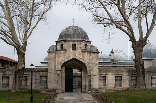 View of the gate on the territory of the Suleymaniye Mosque on a cloudy day, Istanbul, Turkey