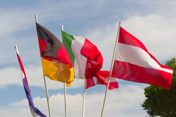 istock German, Italian, Austrian and Swiss flags flutter in the wind. 1697303970