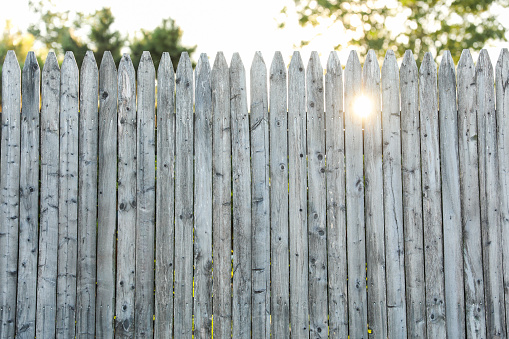 wooden fence, weathered and textured, evoking nostalgia and rural charm, against a soft-focus background, ideal for conveying authenticity and homely warmth