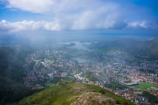 Bergen, Norway, June 23, 2023: A woman hiker takes in the view from the top of Ulriken, the highest point of the Seven Mountains after a morning fog has lifted.