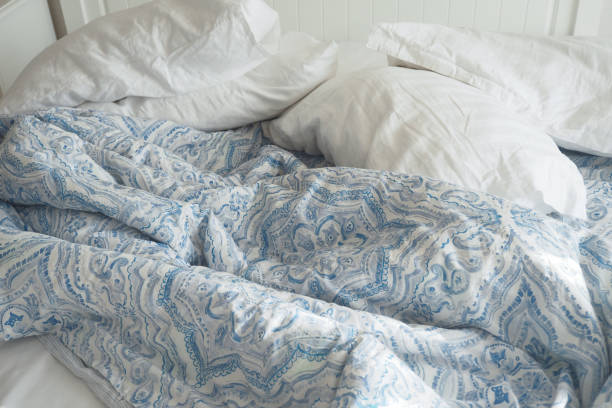 istock messy bed in early morning , messy bed after waking up 1697342015