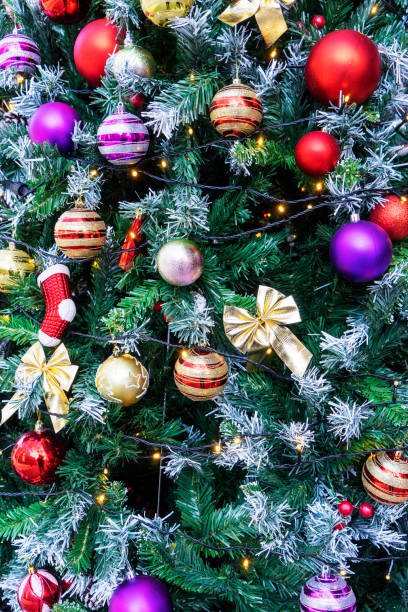 istock Seamless pattern of Christmas tree branchrs with balls. Close up. 1697345430