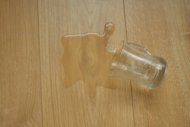 istock a glass of water spilled on floor 1697360628