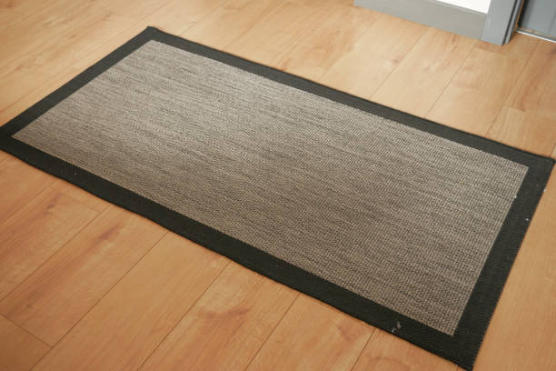 istock Seamless grey carpet texture background on wooden floor with copy space 1697362255