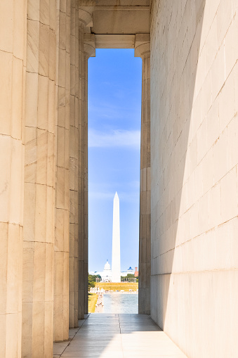 Washington Monument in Washington DC, United States viewed from the Lincoln Memorial columns.