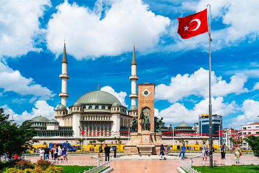 Istanbul, Turkiye - August 1, 2023: Republic Monument and Taksim Mosque in Taksim Square in Istanbul, Turkiye on a sunny day.