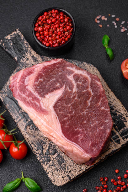 istock Fresh raw beef striploin steak with salt, spices and herbs 1697402066